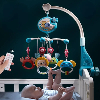 Bébé tout souriant jouant avec son mobile suspendu